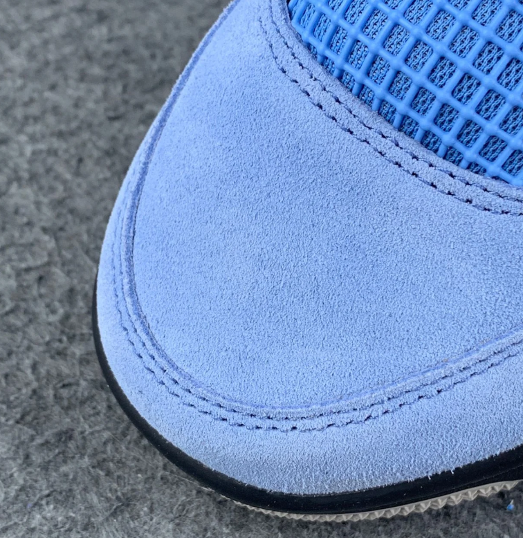 Air Jordan 4 Blue Sneakers with Speckled Gray and Black Accents